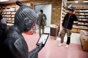 Tokyo, February 15 2012 - Japanese electronic books on display at Kinokuniya book shop in the Shinjuku area. A statue reading on the Sony reader.