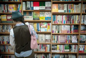Tokyo - Junkudo bookshop - A young japanese girl reading 1Q84, Haruki Murakami's latest novel. The book was a bestseller before it arrives in the bookshops. More than one million copies were sold two weeks after its release.