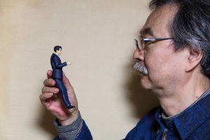 Tokyo, November 9 2014 - Portrait of the manga artist Jiro Taniguchi in his atelier with a figurine of the main character of his series "Kodoku no Gourmet" (le gourmet solitaire in French)).