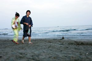 Japanese couple wearing yukata, on the beach of Kamakura before the fireworks