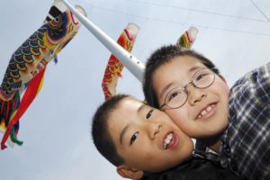Boys from Futaba in front of "Koinobori" (carp streamer) on a pole..Kisai elementary school is a shelter for 1400 displaced people from Futaba city where the Fukushima nuclear plant is located.